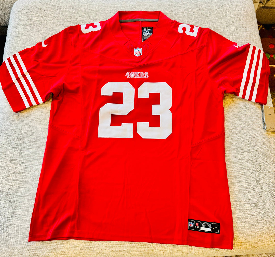 Christian McCaffrey San Francisco 49ers authentic NFL jersey with team logo and player name in red and gold colors.