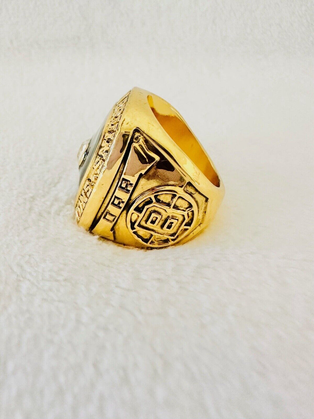1970 Boston Bruins Stanley Cup hockey ring with engraved details, crafted by EBSportsRings.com, in a close-up view.