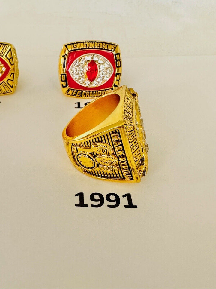 Washington Commanders championship ring in gold with team logo, engraved details, and decorative gemstones.