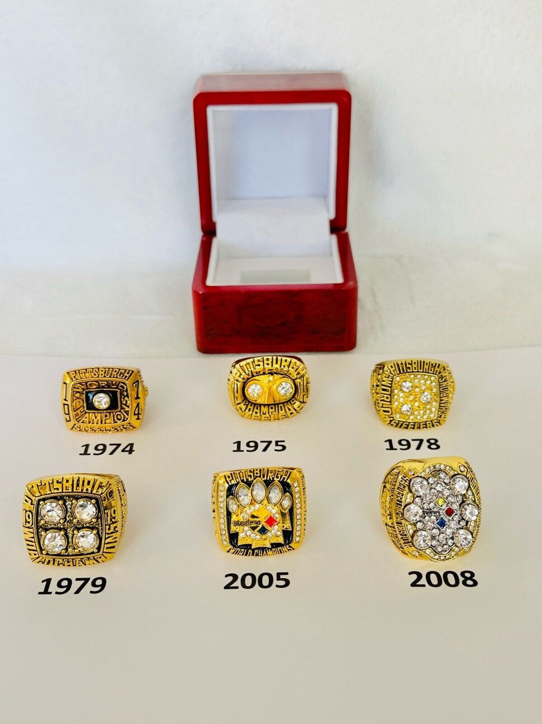 Pittsburgh Steelers Super Bowl championship ring with customizable player number, displayed in a box, NFL sports memorabilia.