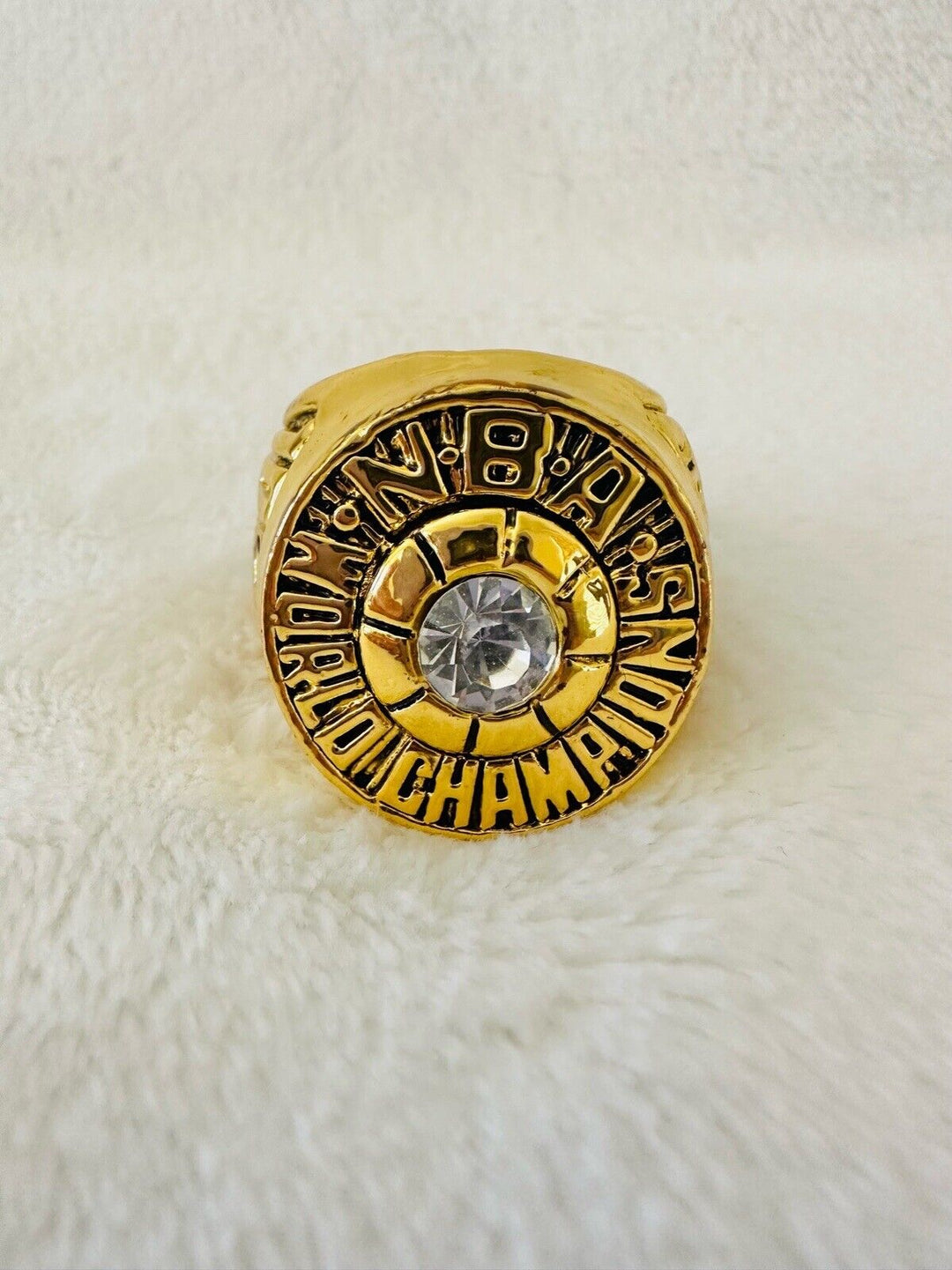 Milwaukee Bucks 1971 championship Kareem Abdul-Jabbar NBA ring with team engravings, displayed on a white background.