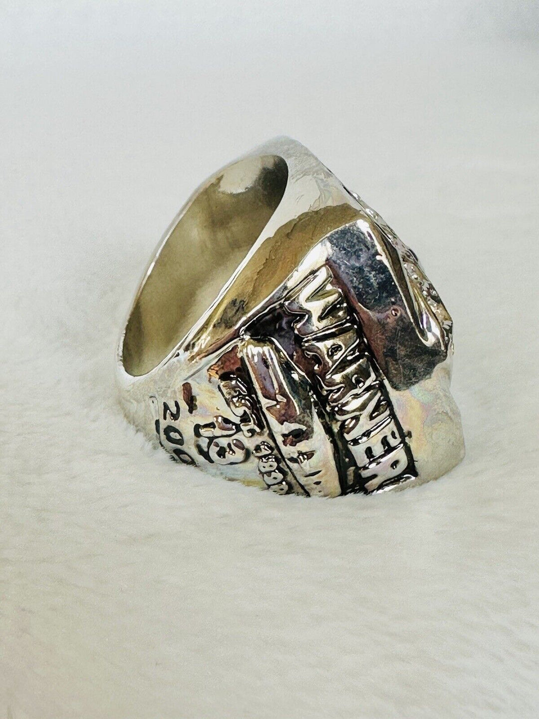 Arizona Cardinals 2009 Super Bowl championship ring with team logo and intricate detailing, displayed prominently.