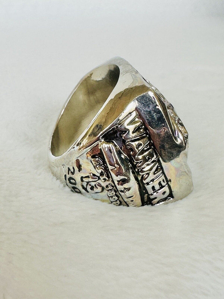 Arizona Cardinals 2009 Super Bowl championship ring with team logo and intricate detailing, displayed prominently.