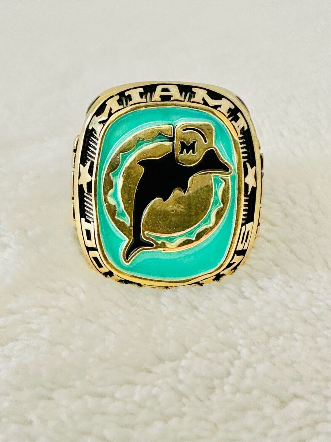 Large gold-plated Miami Dolphins NFL ring featuring team logo, classic design, and intricate detailing, ideal for sports fans.