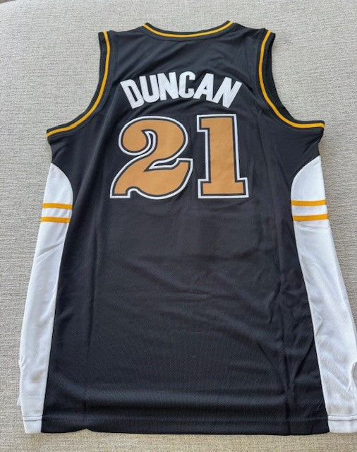 Wake Forest Tim Duncan college jersey with stitched number 21, displayed on a hanger, featuring team colors and official NCAA branding.